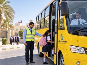 A bus attendant in a high-visibility vest helps a student with a pink backpack board a yellow AlRrai Combined school bus while the driver waits at the wheel.